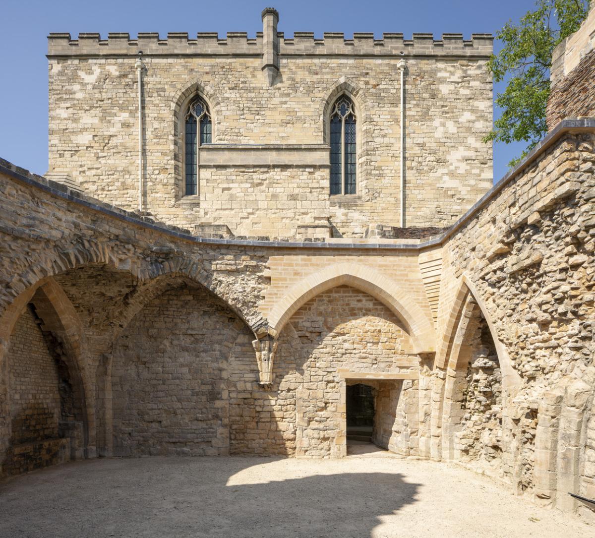 Medieval palace walls featuring reinstated archways blending medieval with new work