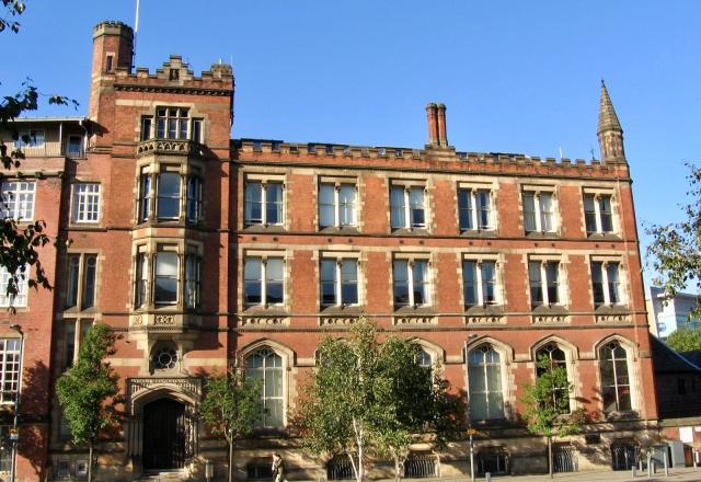 External image of a very large and proud Victorian building. It is three storeys with feature arch windows at the ground floor. 