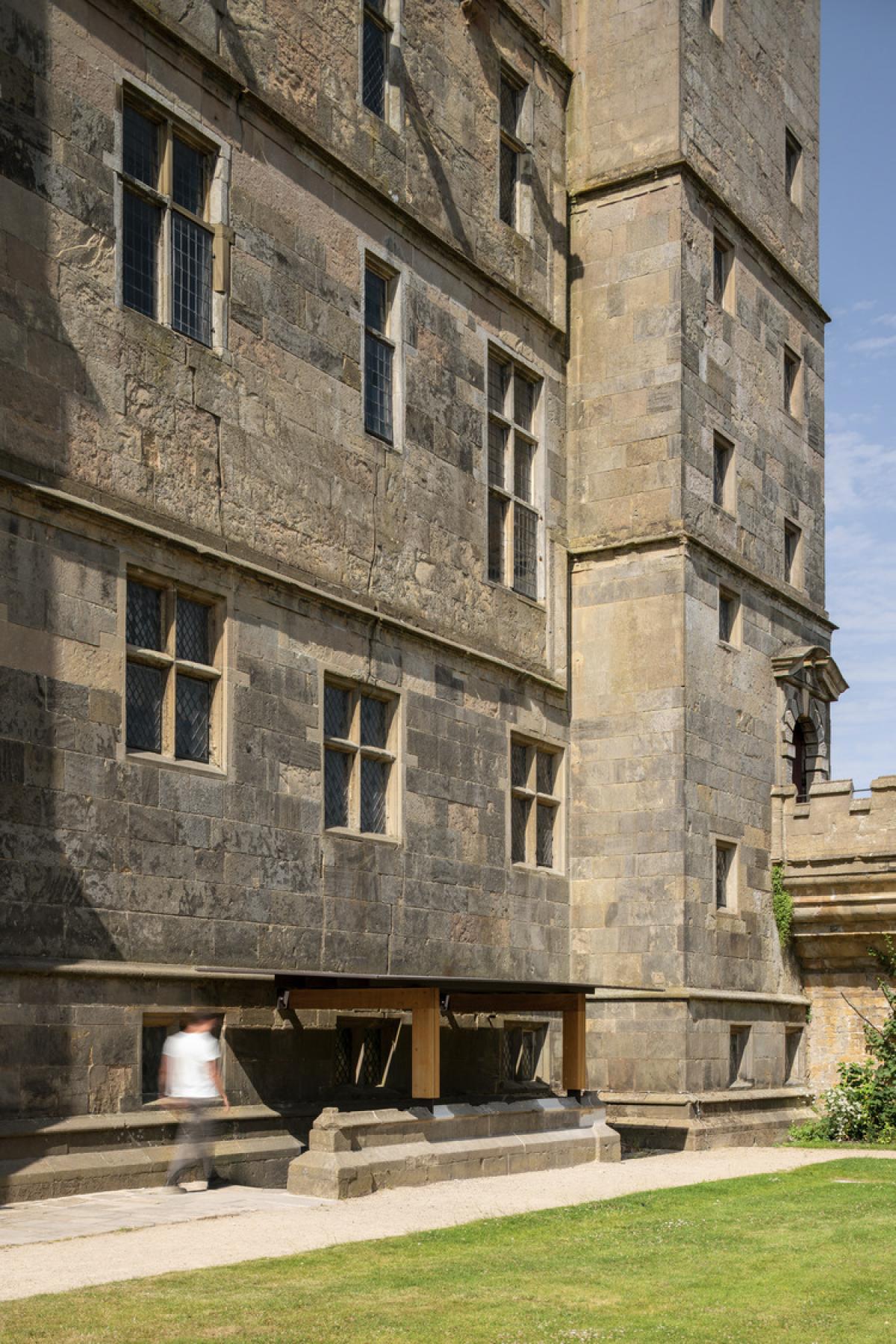 Exterior image of a Grade I listed castle with contemporary rainwater canopy.