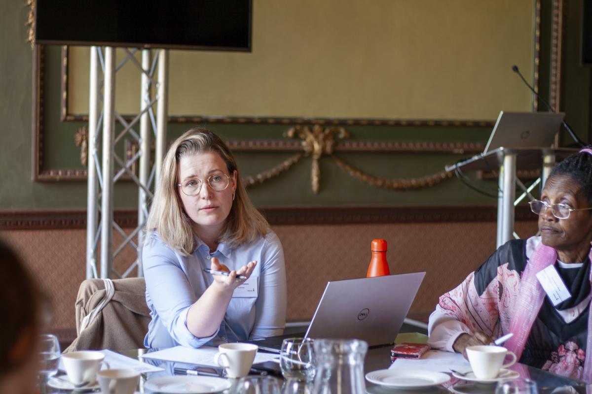 A lady in a blue shirt leads a discussion