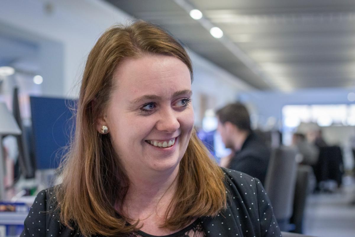 headshot of lucy ashcroft, looking off to side, smiling laughing