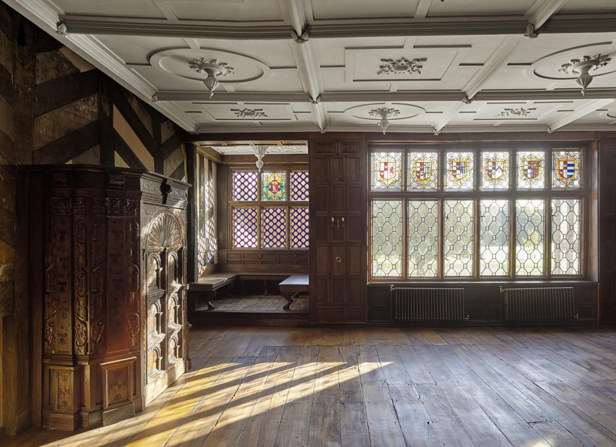 Interior of a 16th century manor house. The building, which was destroyed by fire, has been restored. Light is filtering through the window.