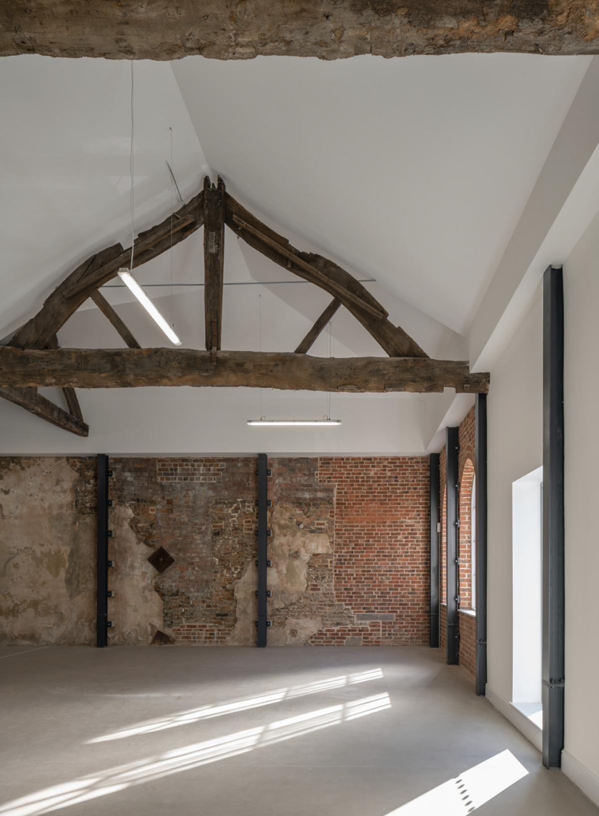 interior of first white cloth hall, showing vacant room and wooden beams