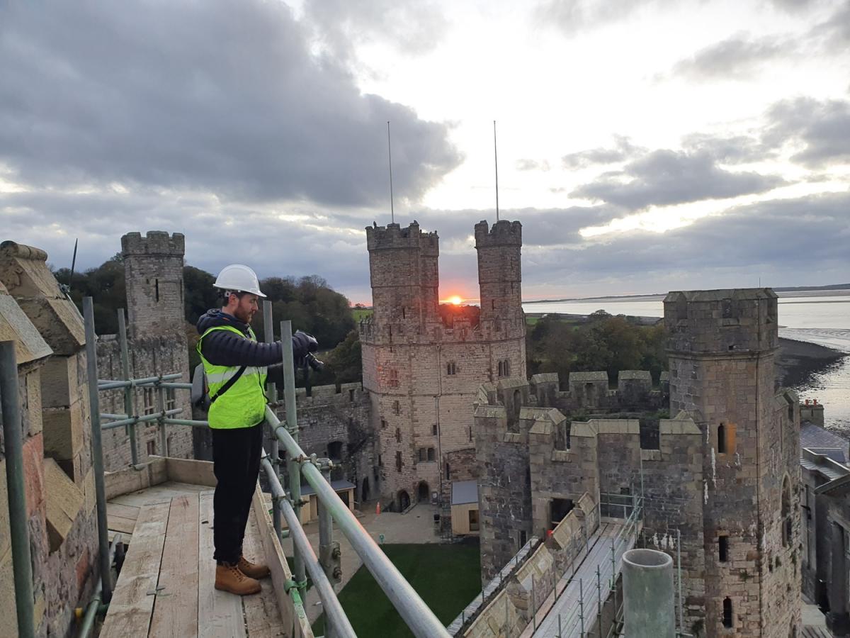 buttress team member photographing aerial view of castle during sunset