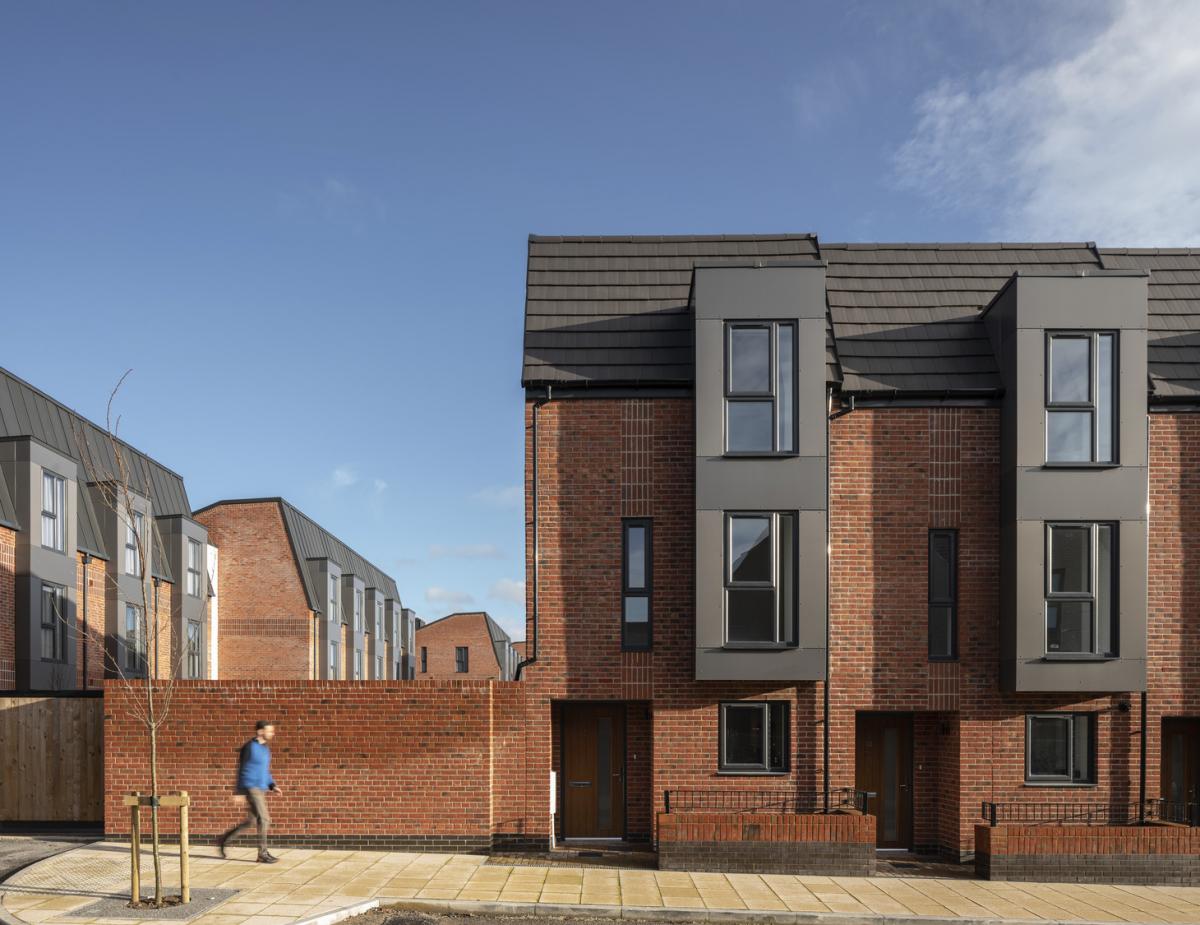 exterior view of depot townhouses, pedestrian walking