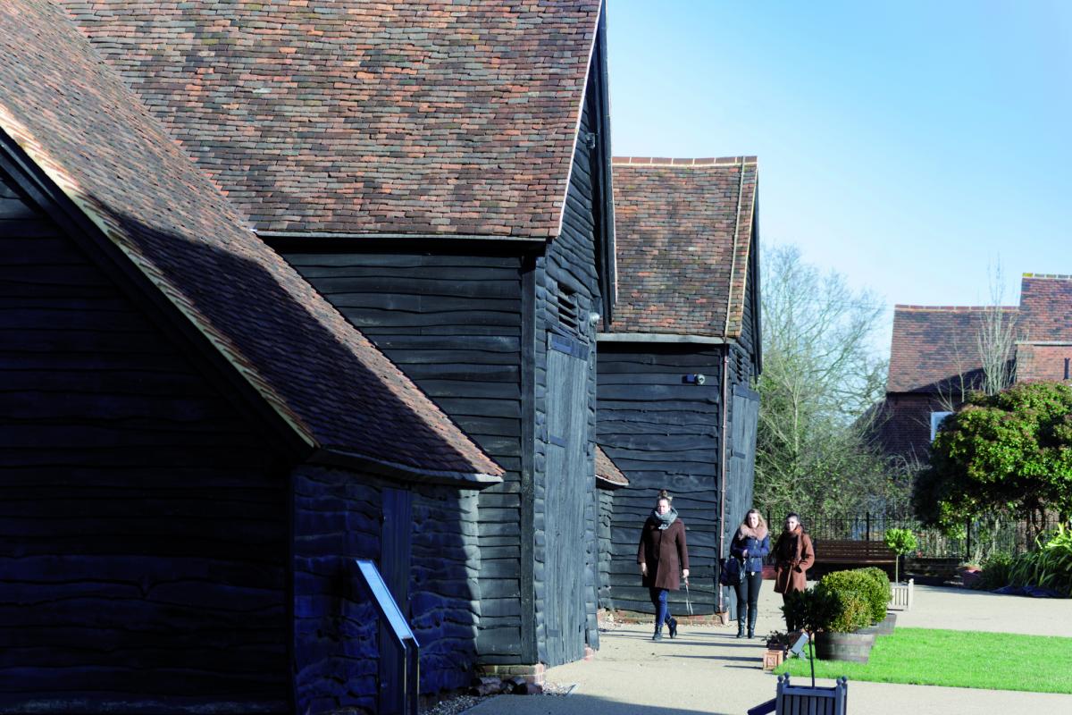 exterior of headstone manor with visitors walking alongside