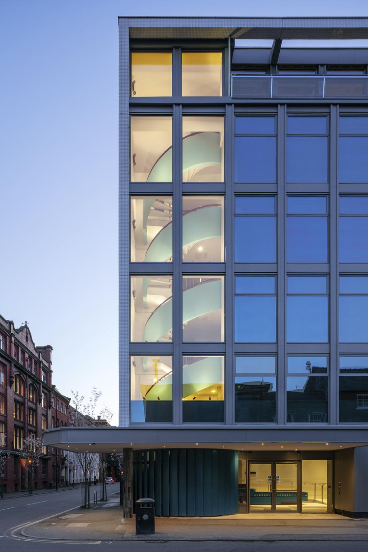 exterior view of hilton house, glass building at dusk