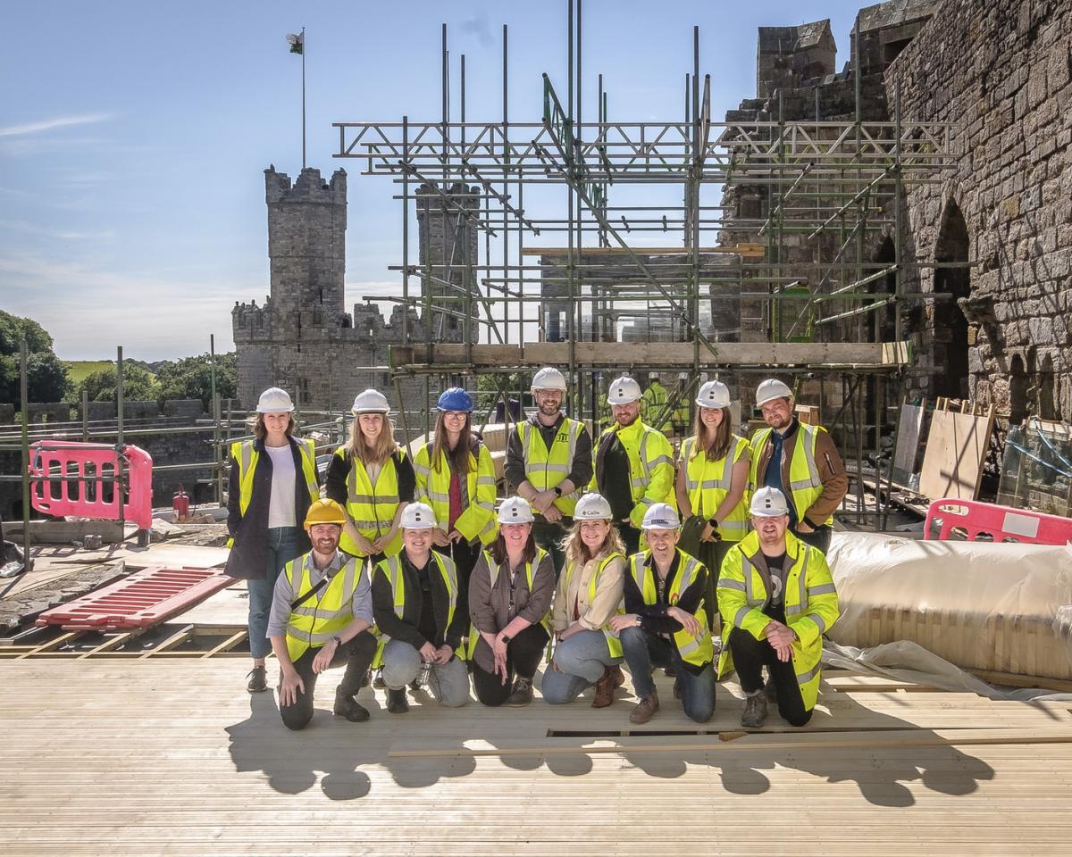 buttress group in hi-vis posing at caernarfon castle