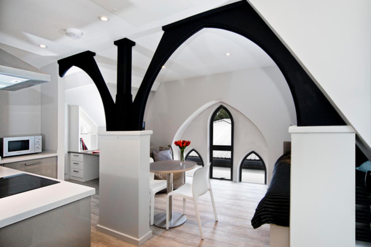 interior of unitarian chapel, white wall, black beams and modern furnishing