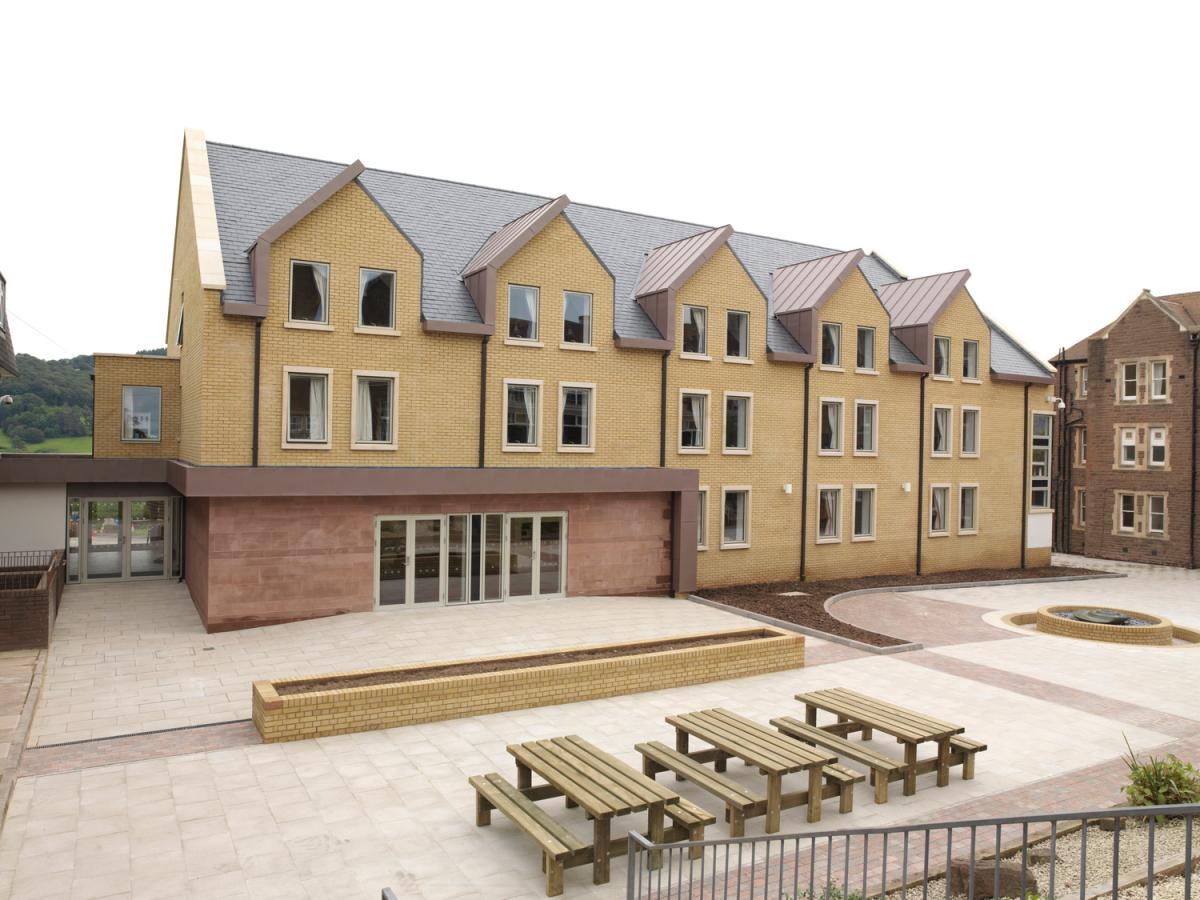 Exterior image of a school boarding house and courtyard.