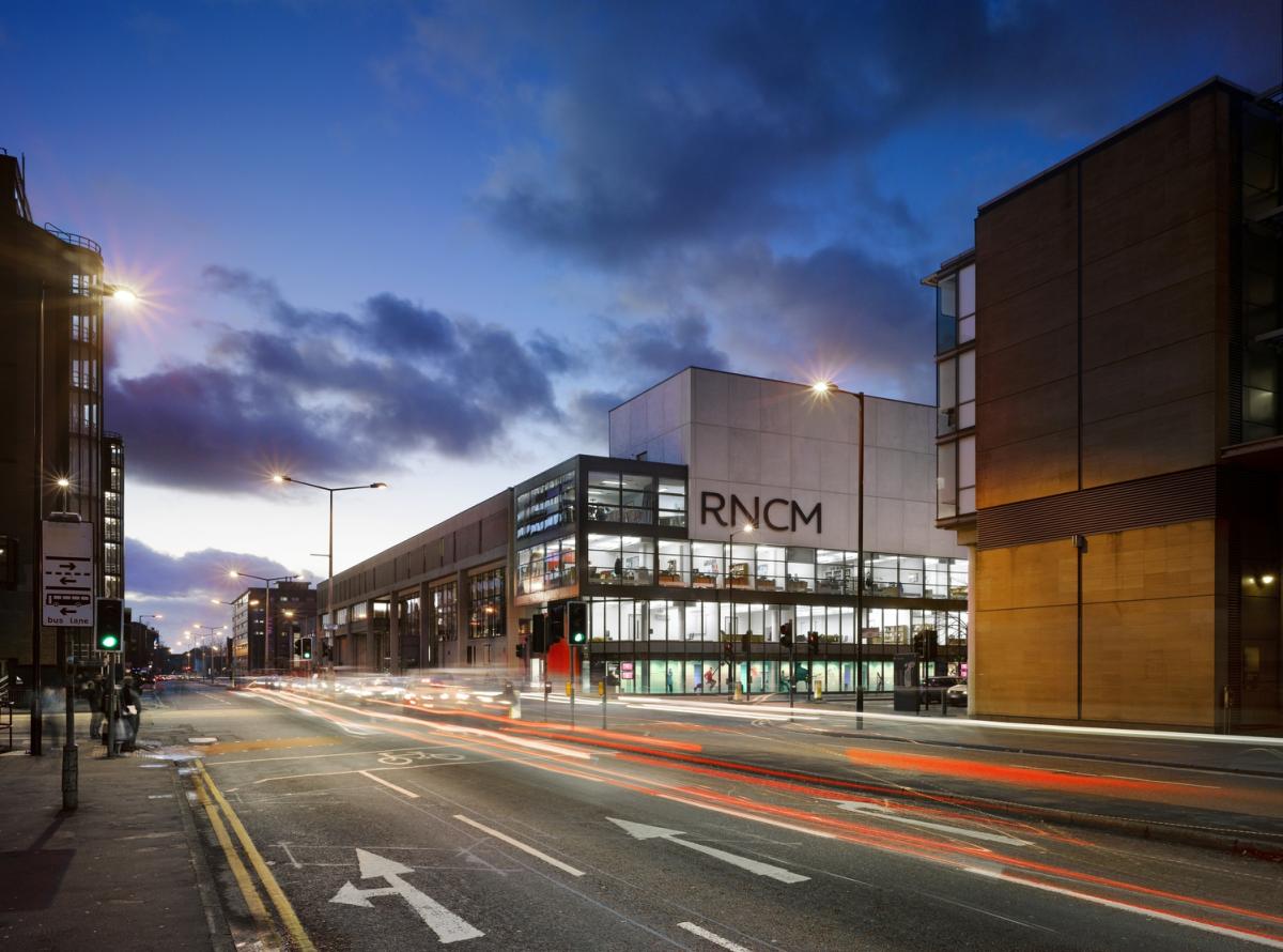 Exterior image of a modern conservatoire at night.