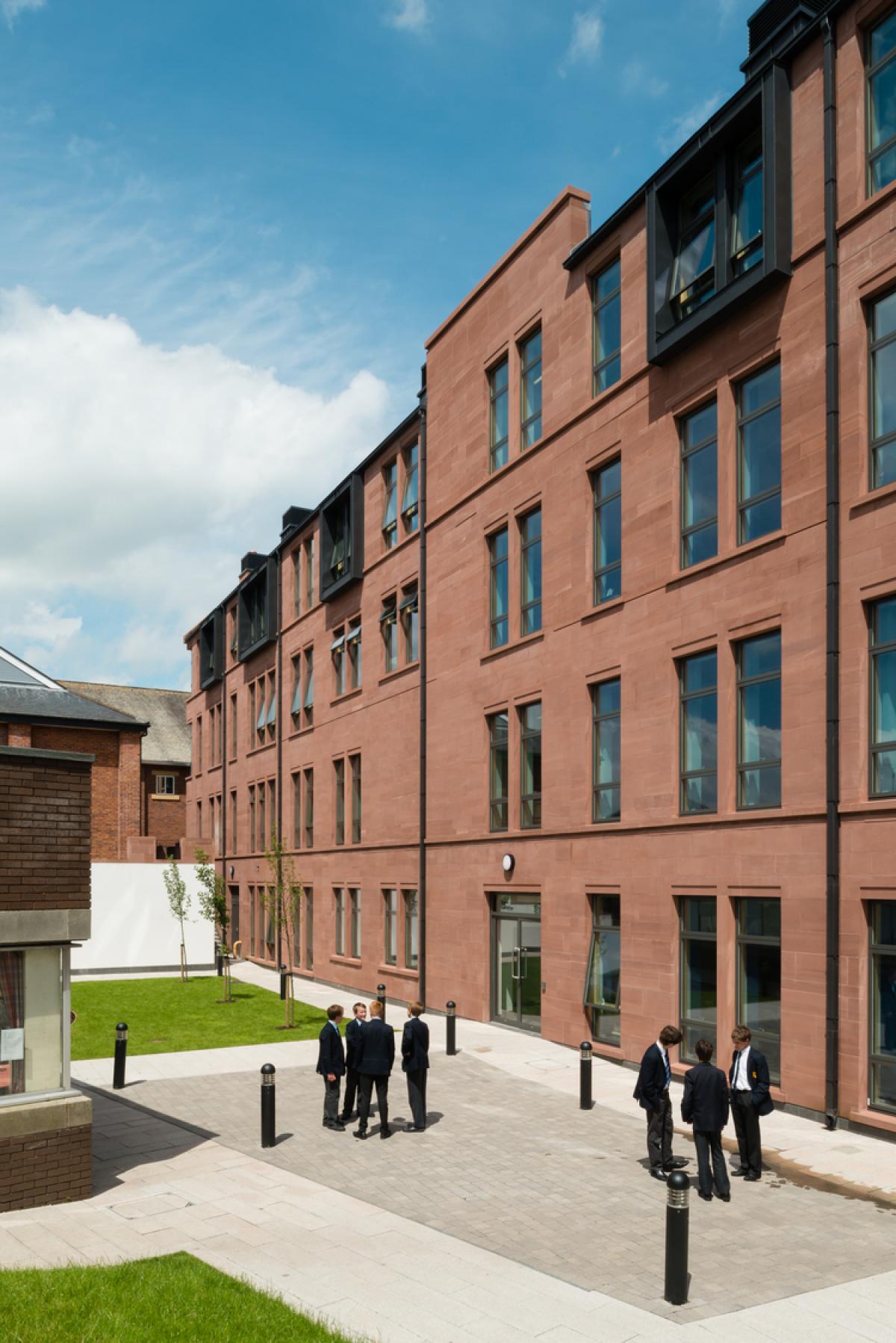 Exterior image of a red sandstone academic building.