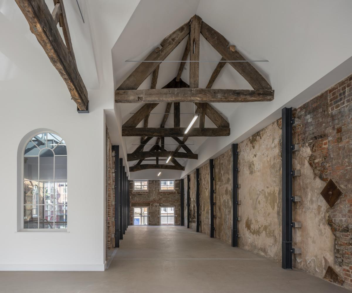 interior of first white cloth hall, white walls and triangular ceiling beams