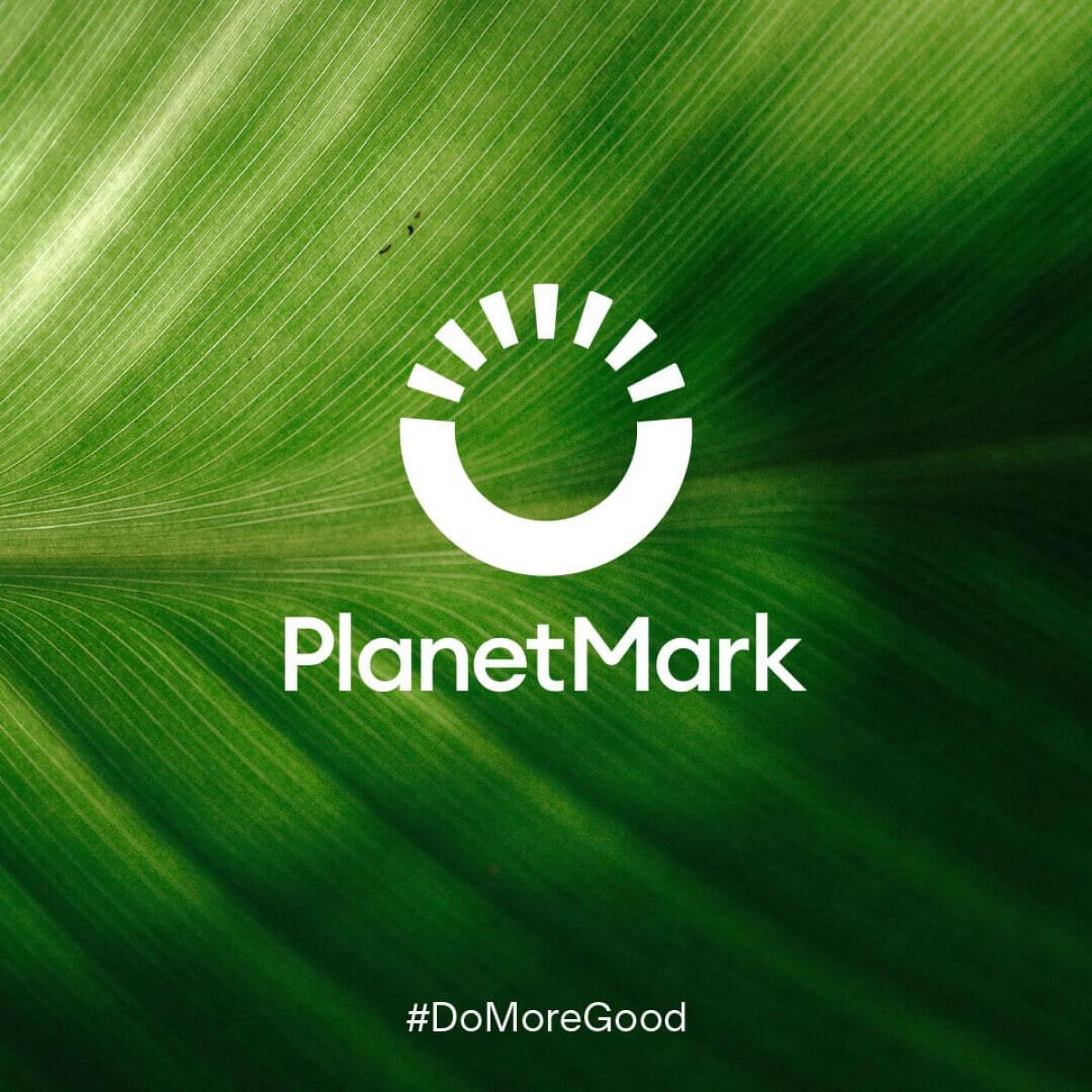 planet mark logo depicting circle with half portrayed as rays on green leaf background