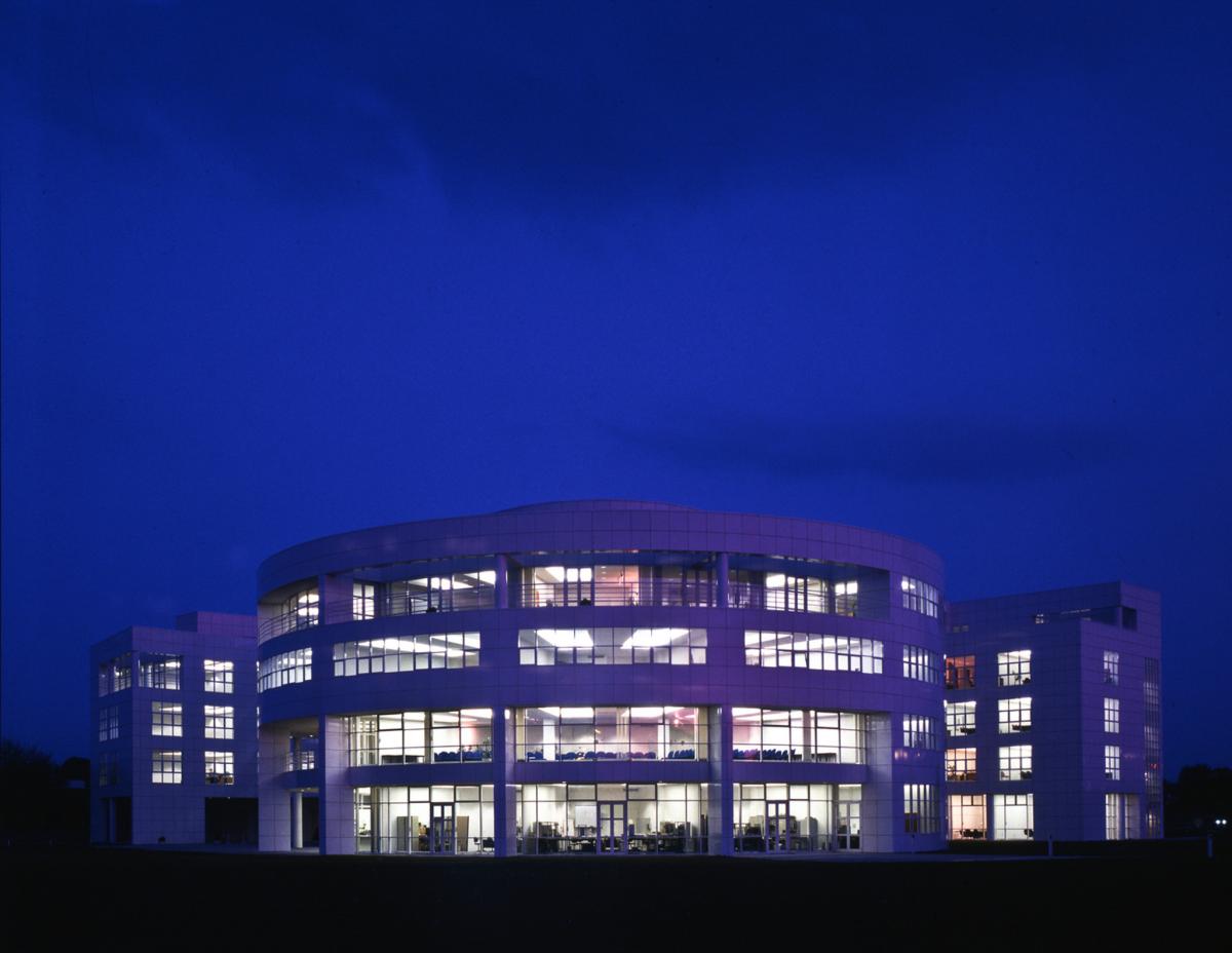 exterior of sir williams siemens house large white building with grass outside at night