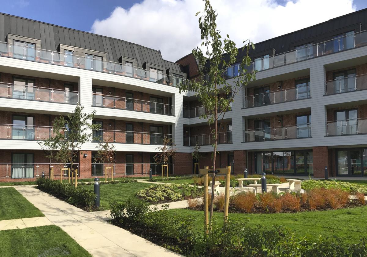 exterior of elmswood park, showing inner corner of block of apartments and green garden square