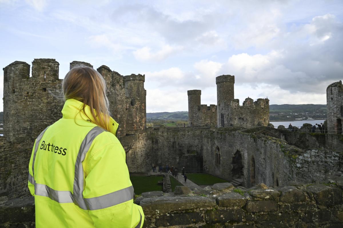 A woman looking at World Heritage Site, Caernarfon Castle.