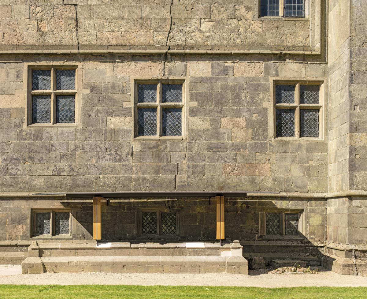 a canopy in front of a stone façade