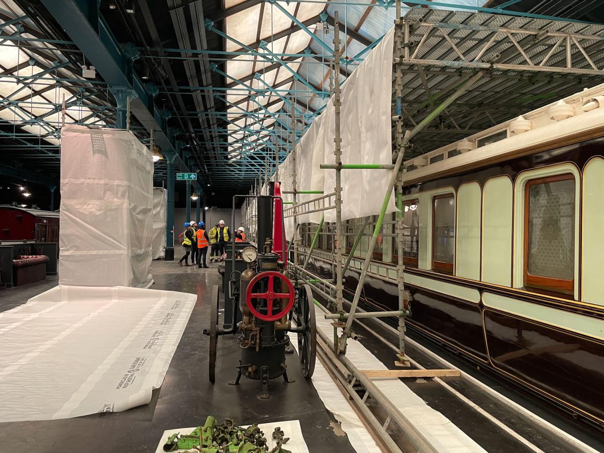 Train surrounded by scaffold.
