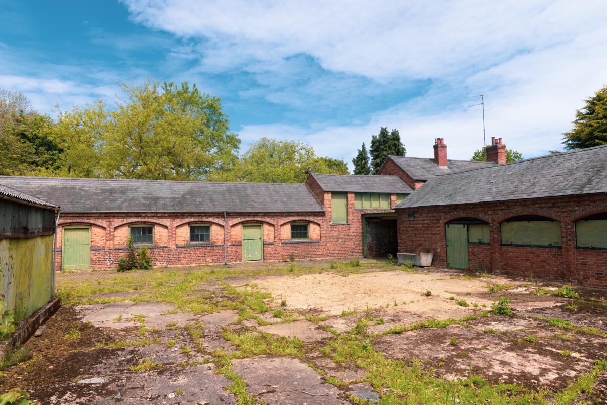 Colour picture of vacant riding stables.  
