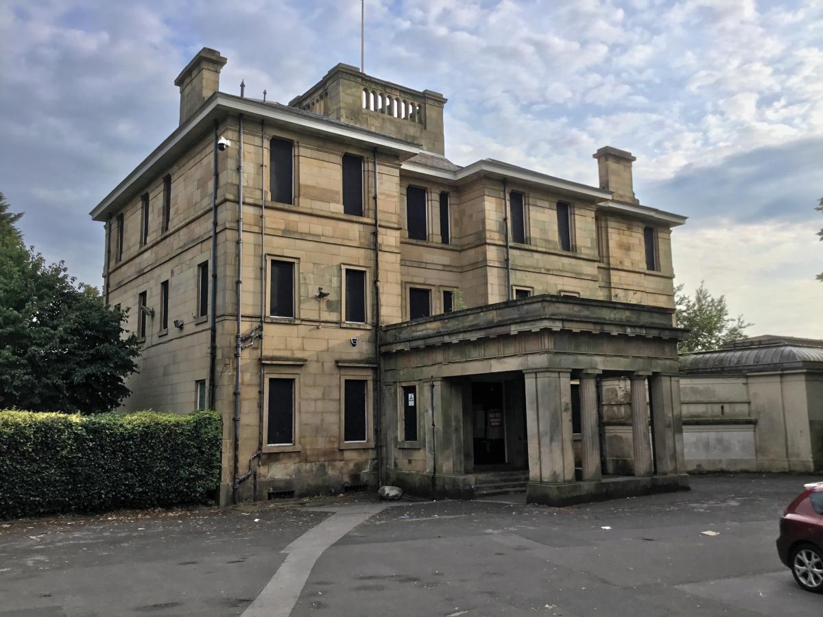 Large old grand mansion house with a blue sky