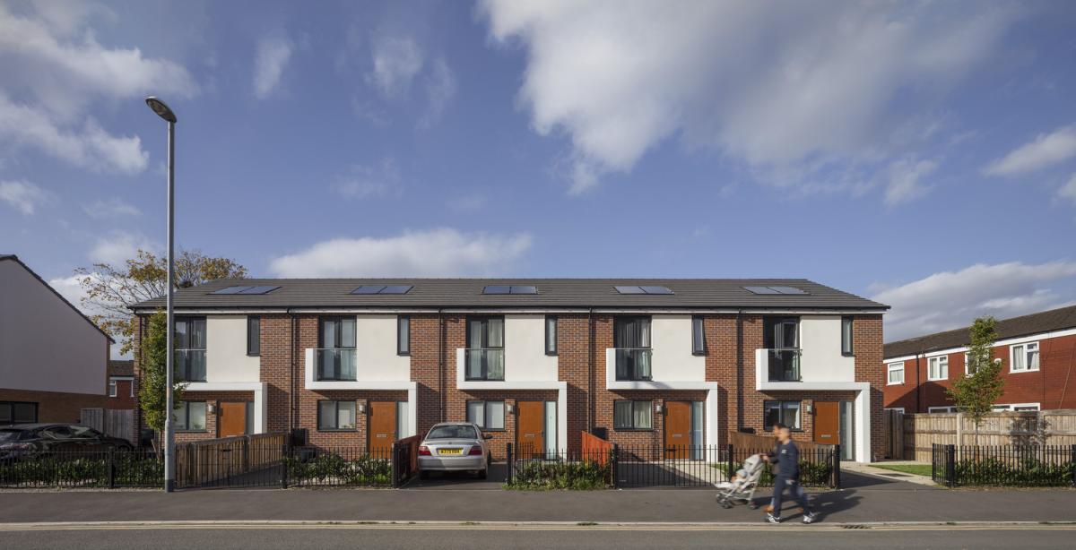 a row of five, two-storey brick and render houses in Brunswick