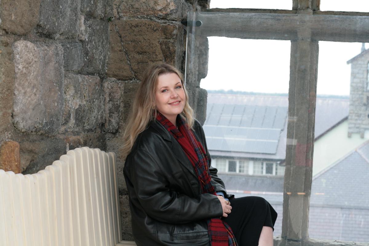 Jenna Johnston, sitting on the window seating of the top deck at Caernarfon Castle