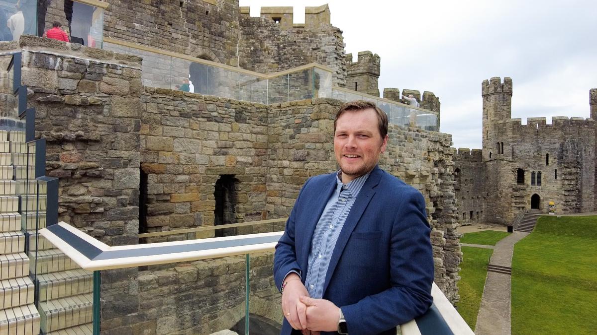 Alex Scrimshaw, standing at the railings at Caernarfon