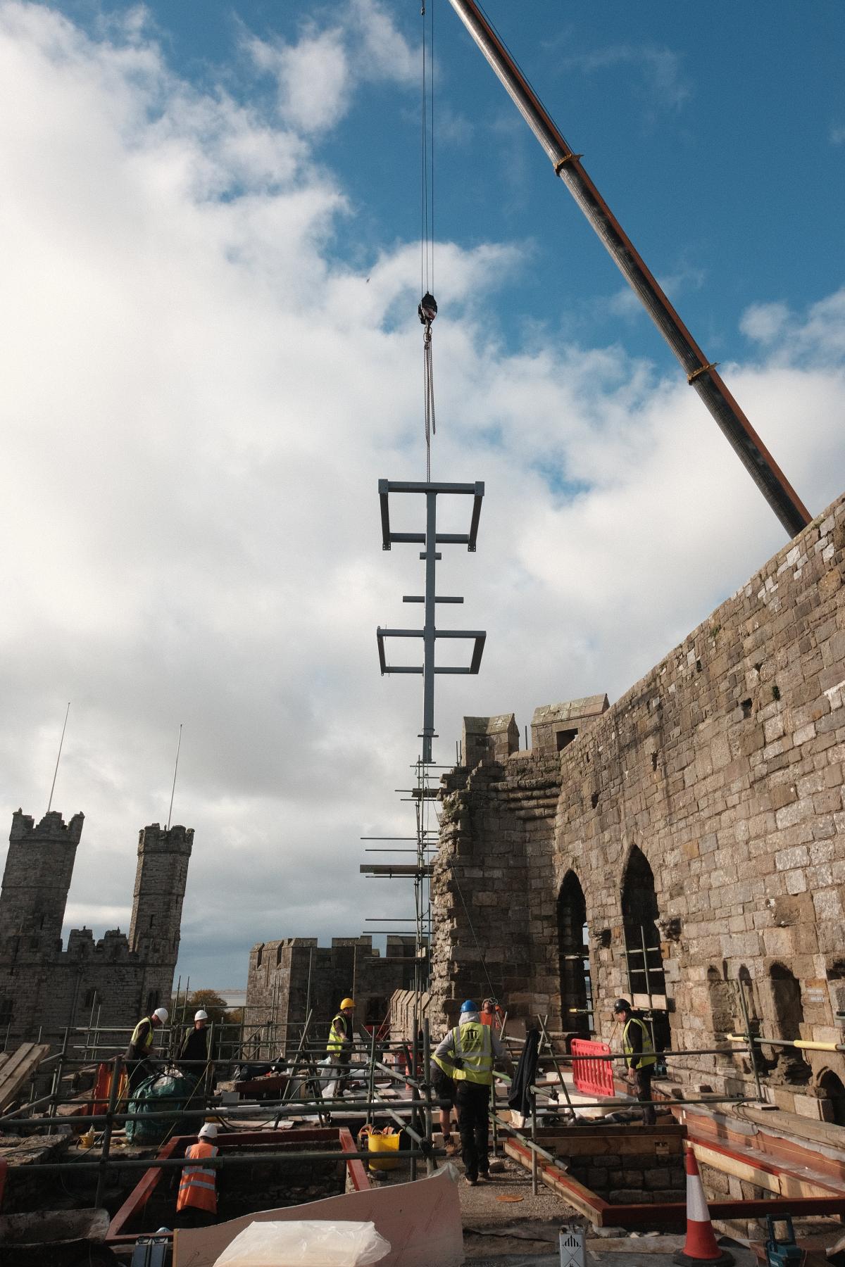 Construction image of the lift installation at Caernarfon Castle - a crane placing the lift on the upper deck.