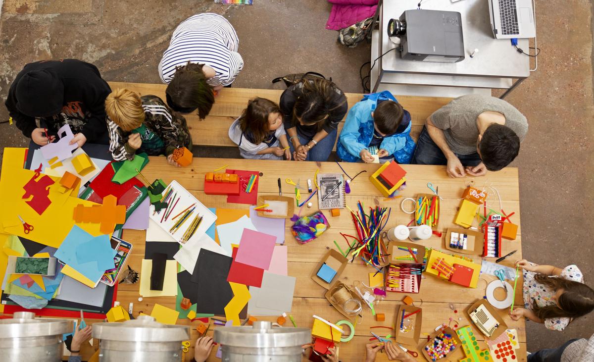 Bird eye view of crafts workshop table with children