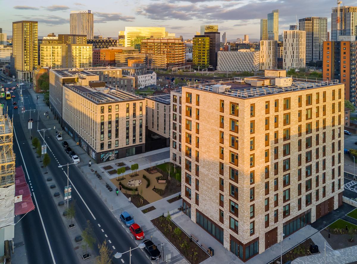 greenhaus and atelier at sunset with the Manchester skyline behind