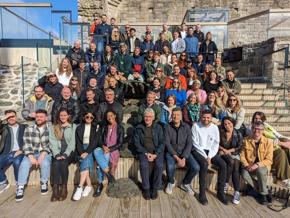 Group of people posing for a photograph on a sunny day