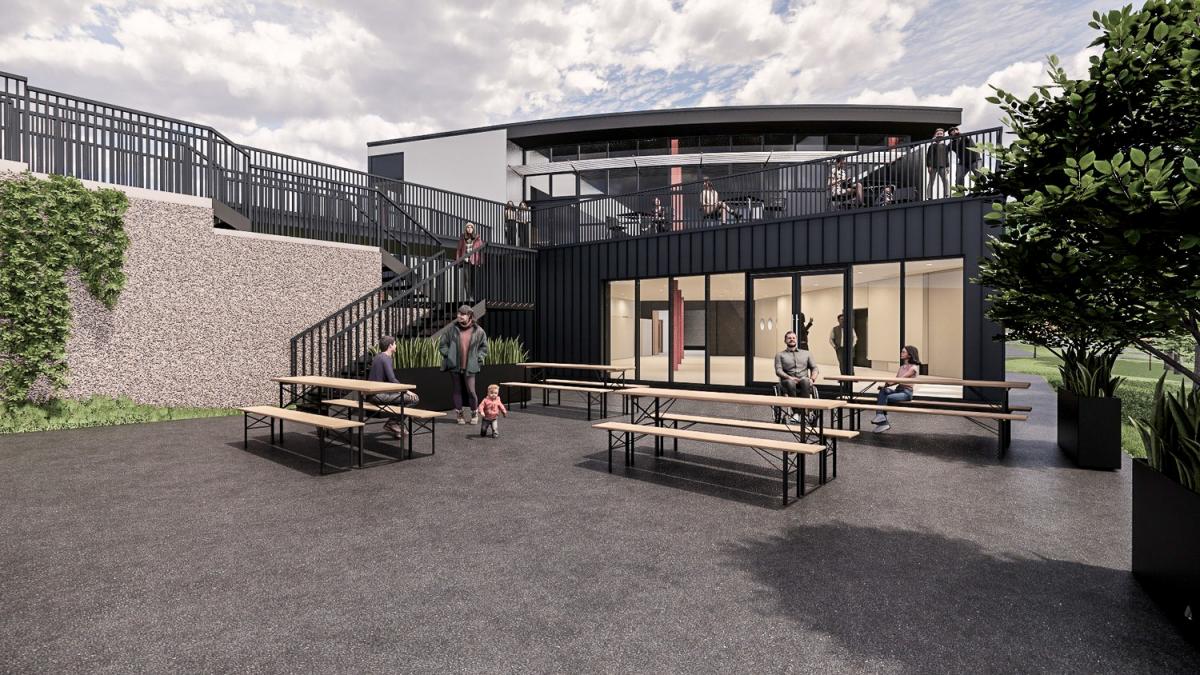 CGI of Anderton Boat Lift - a courtyard with picnic benches and a black panelled building with large windows