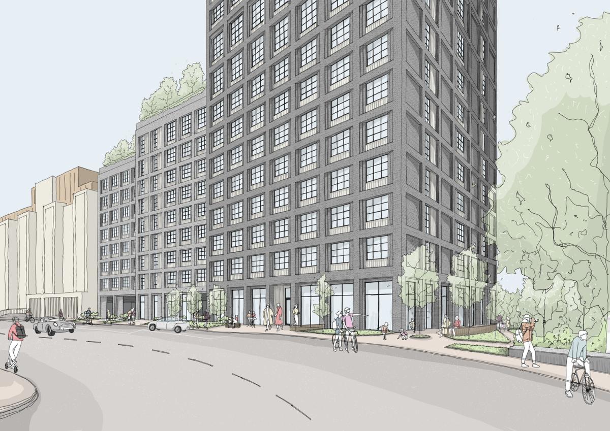 Grey building with windows on a road.