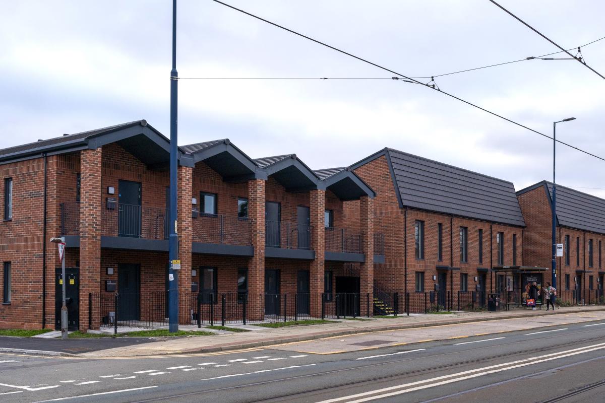 Street view which shows the houses seen in the previous photograph alongside the six affordable two bedroomed properties. 