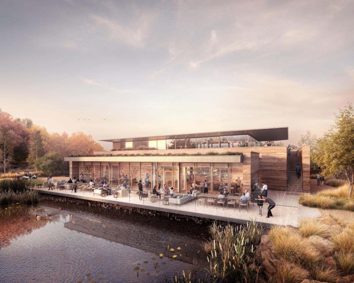 Chester Zoo restaurant - a wooden building with people eating at tables on a deck. The deck overlooks water.