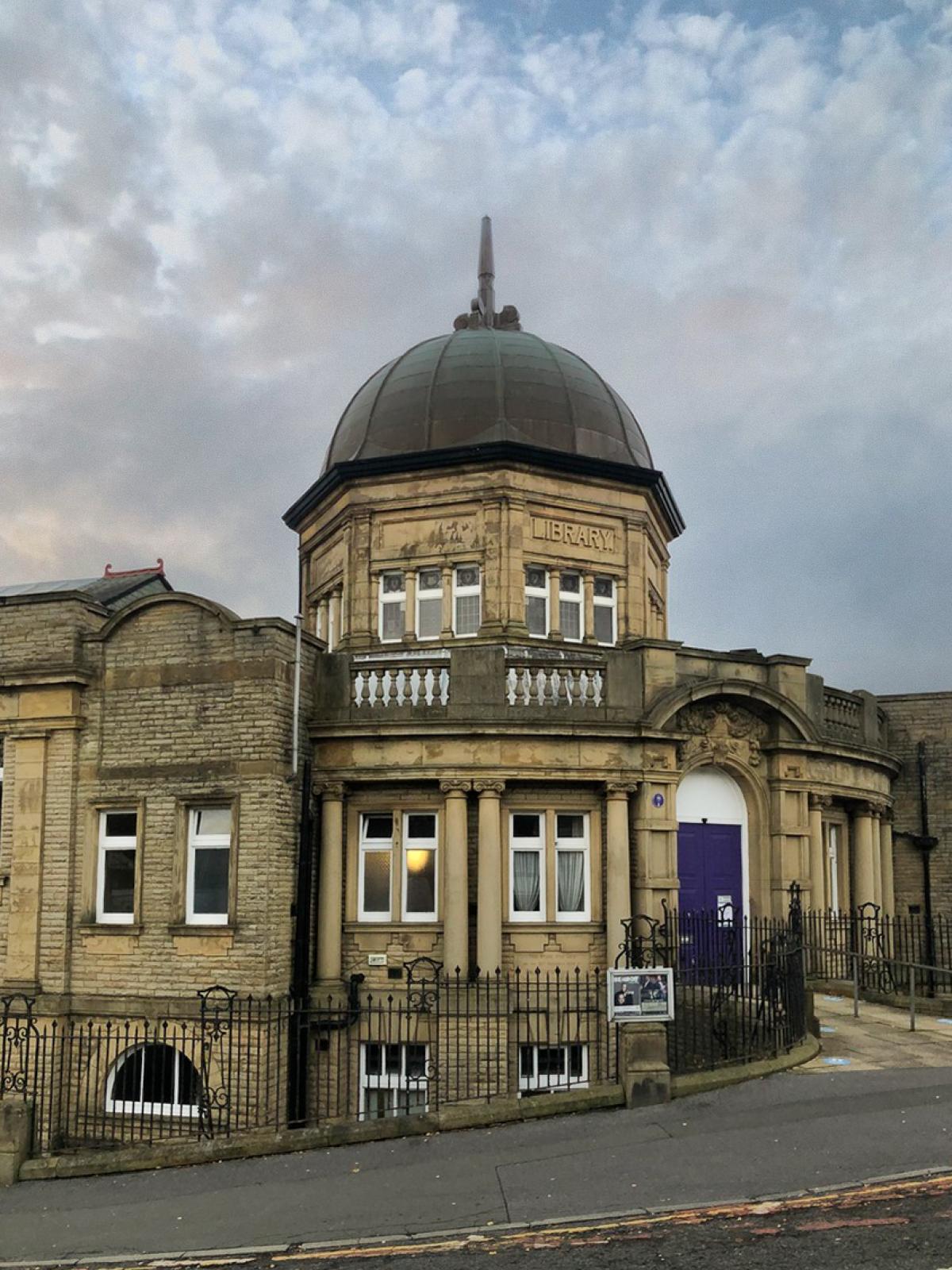 An historic stone building with a dome and spire.