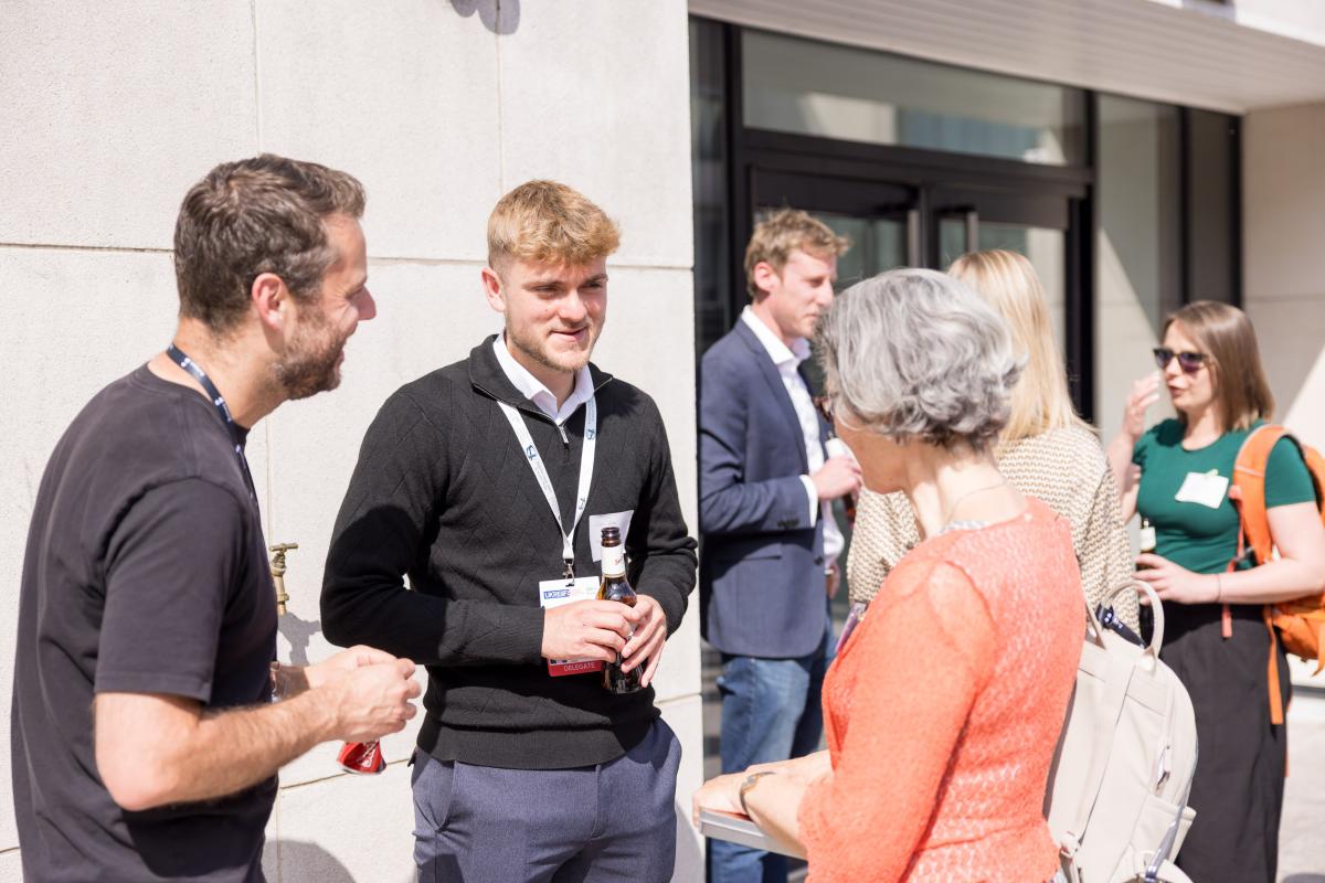 Group of people networking on an outside sunny terrace