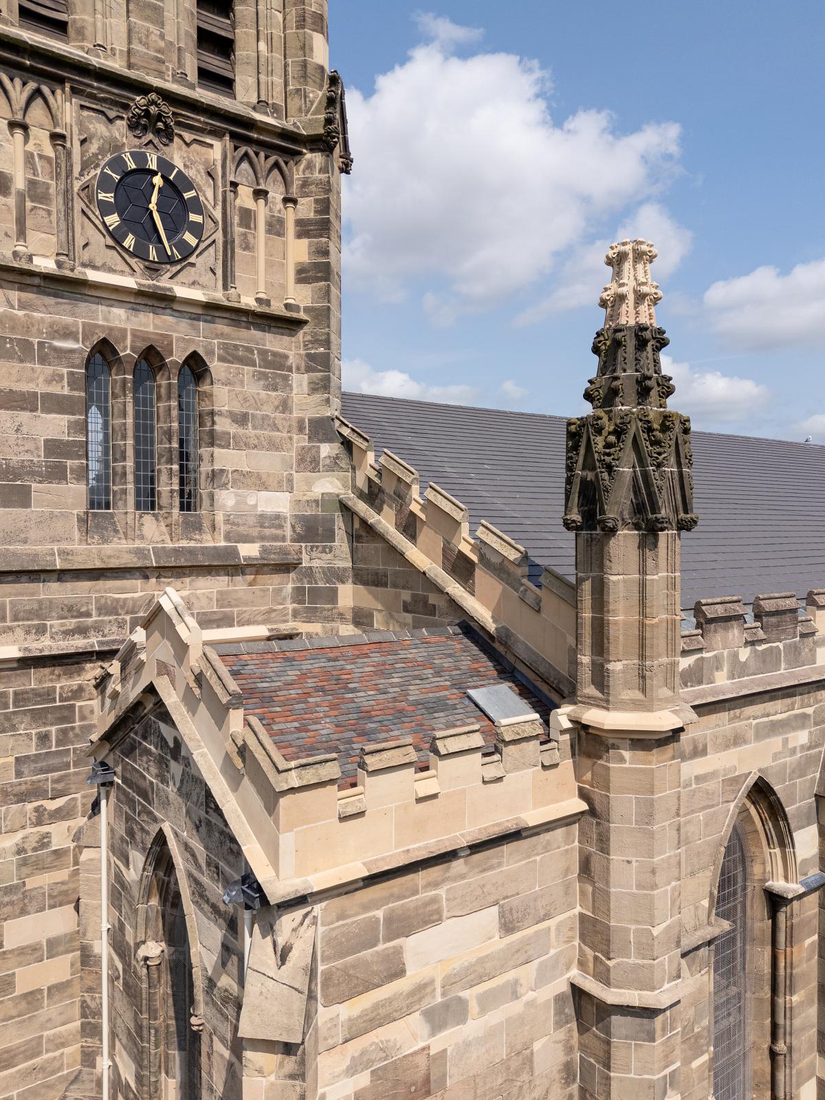 Exterior of the church - stone tower with a clock