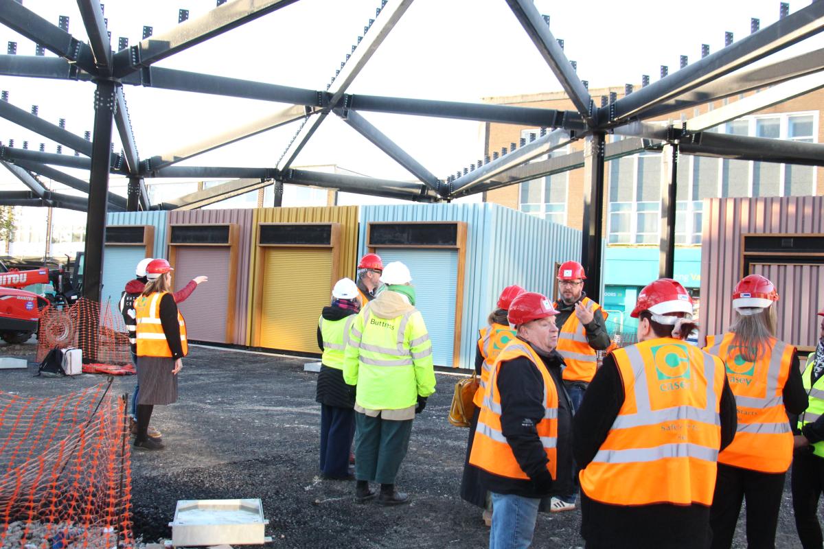 A group of people in high vis jackets and hard hats