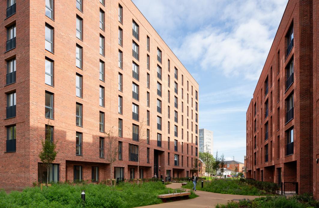 Photography of No.1 Ancoats Green - a red brick residential building with exterior landscaping