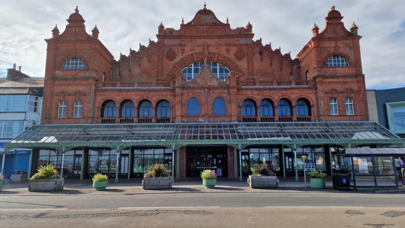 Ornate Victorian theatre fronting onto a road.  It has a glass canopy at the front of the building.  