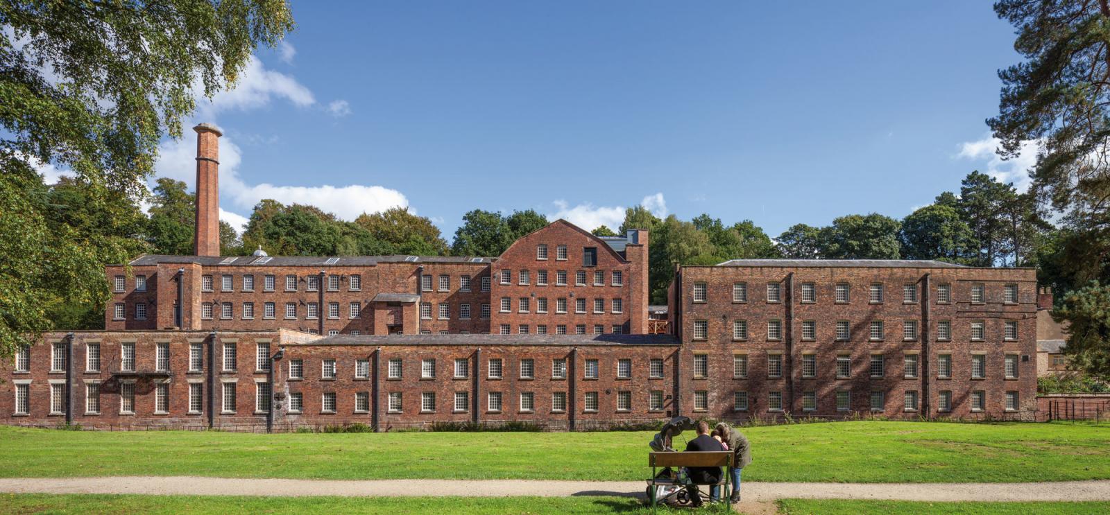 exterior of quarry bank mill, lengthy historic red brick building