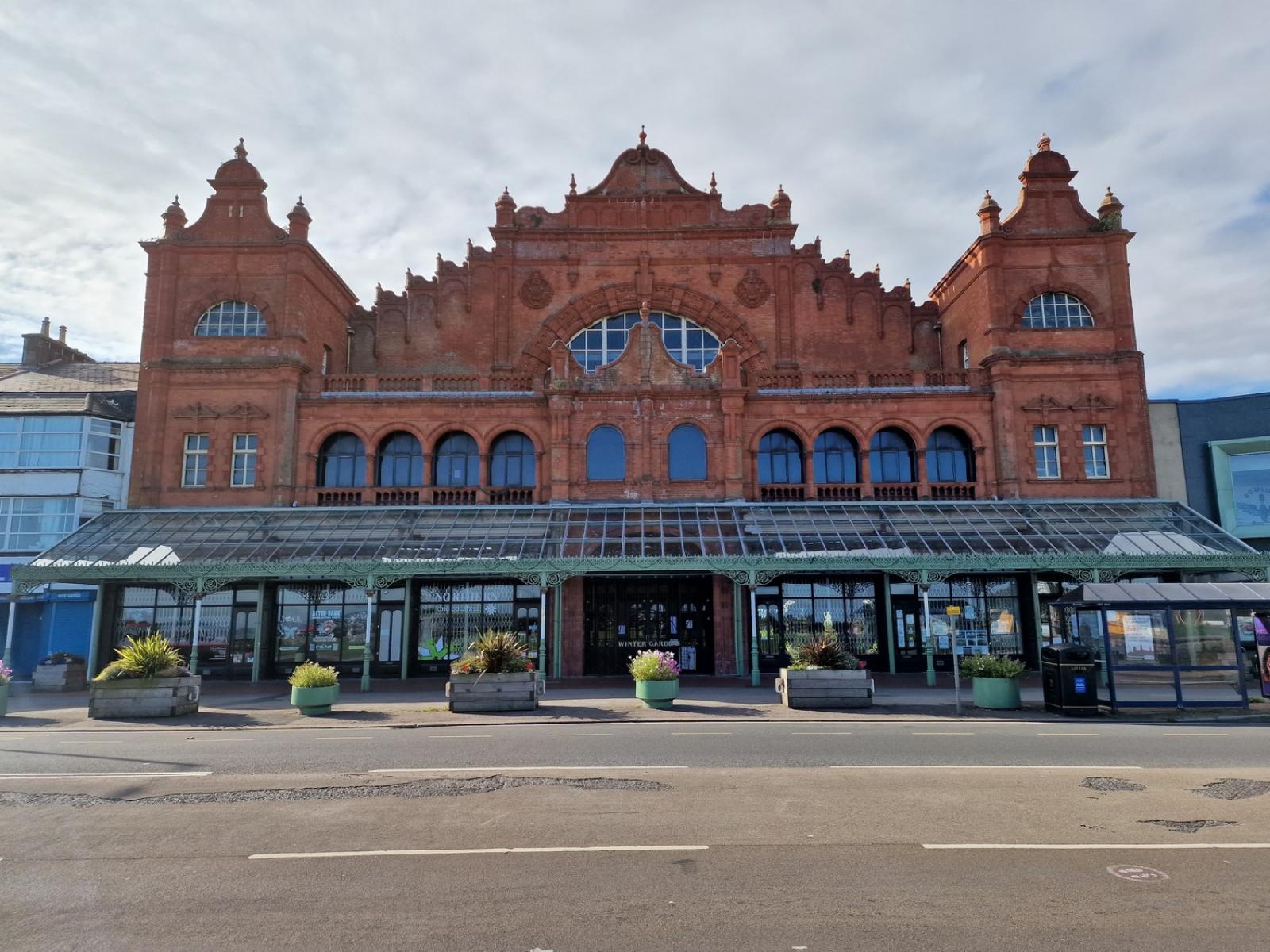 Ornate Victorian theatre fronting onto a road.  It has a glass canopy at the front of the building.  