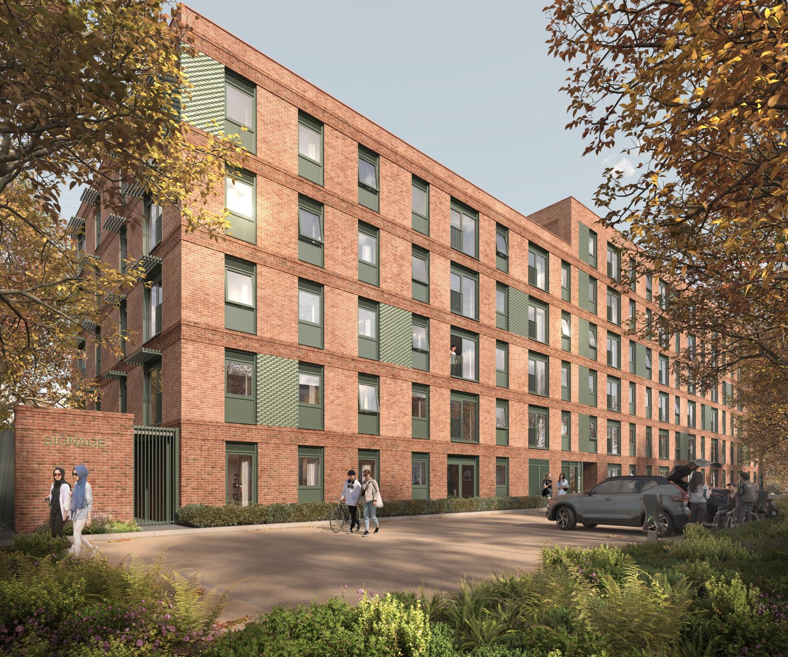 Pink/brown block of apartments on a tree lined area