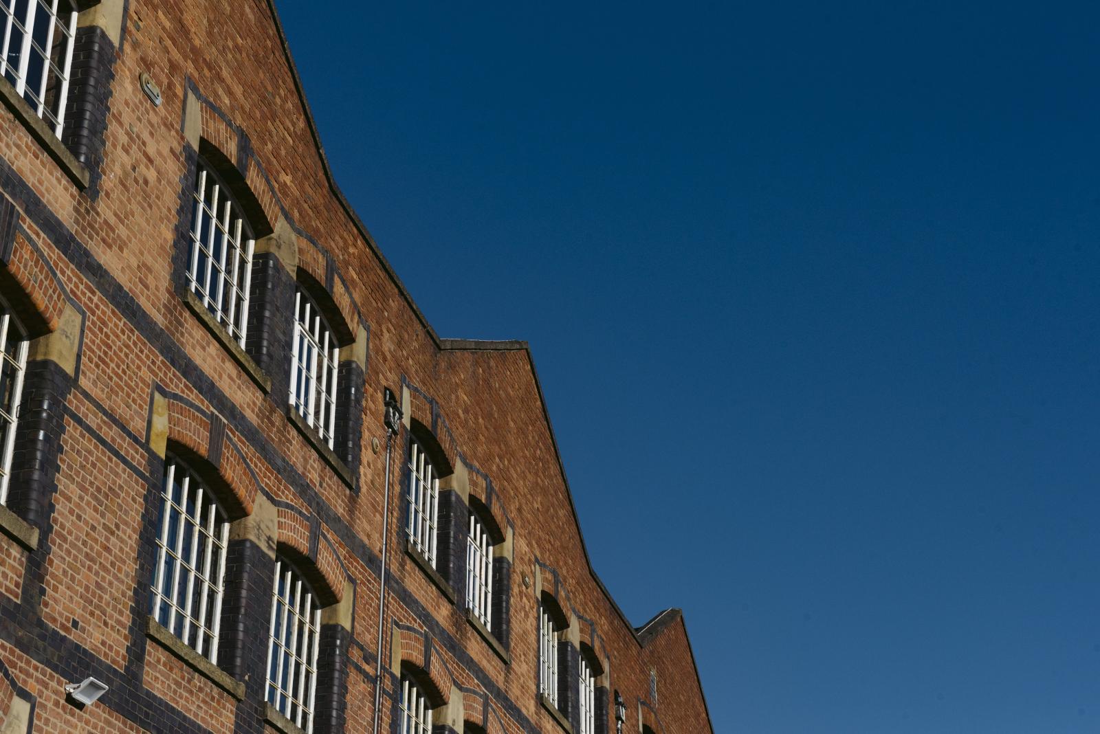 The top portion of the new warehouse with a blue sky background.