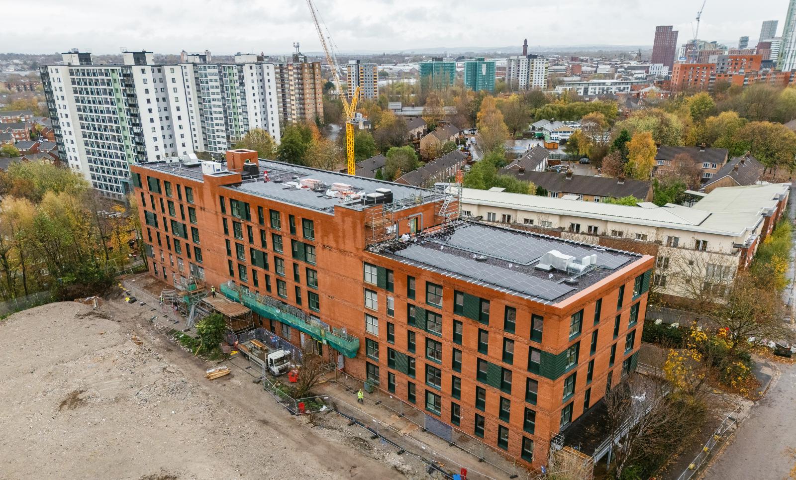 Over head photo of the Willohaus apartment block, showing the surrounding areas and into the distance the neighbouring tower blocks and landscape.