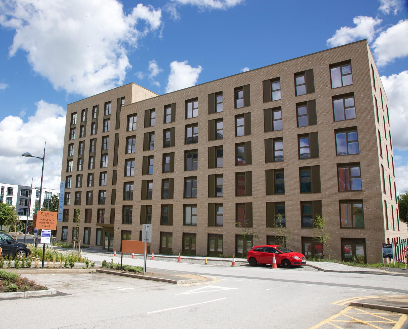 A new large apartment block in light brick