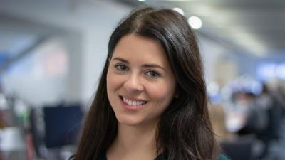 Headshot of Francesca Mainman. A smiling woman with long dark hair.