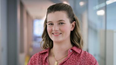 Headshot of Georgia Rose-Garside. A woman smiling, wearing a pink blouse.